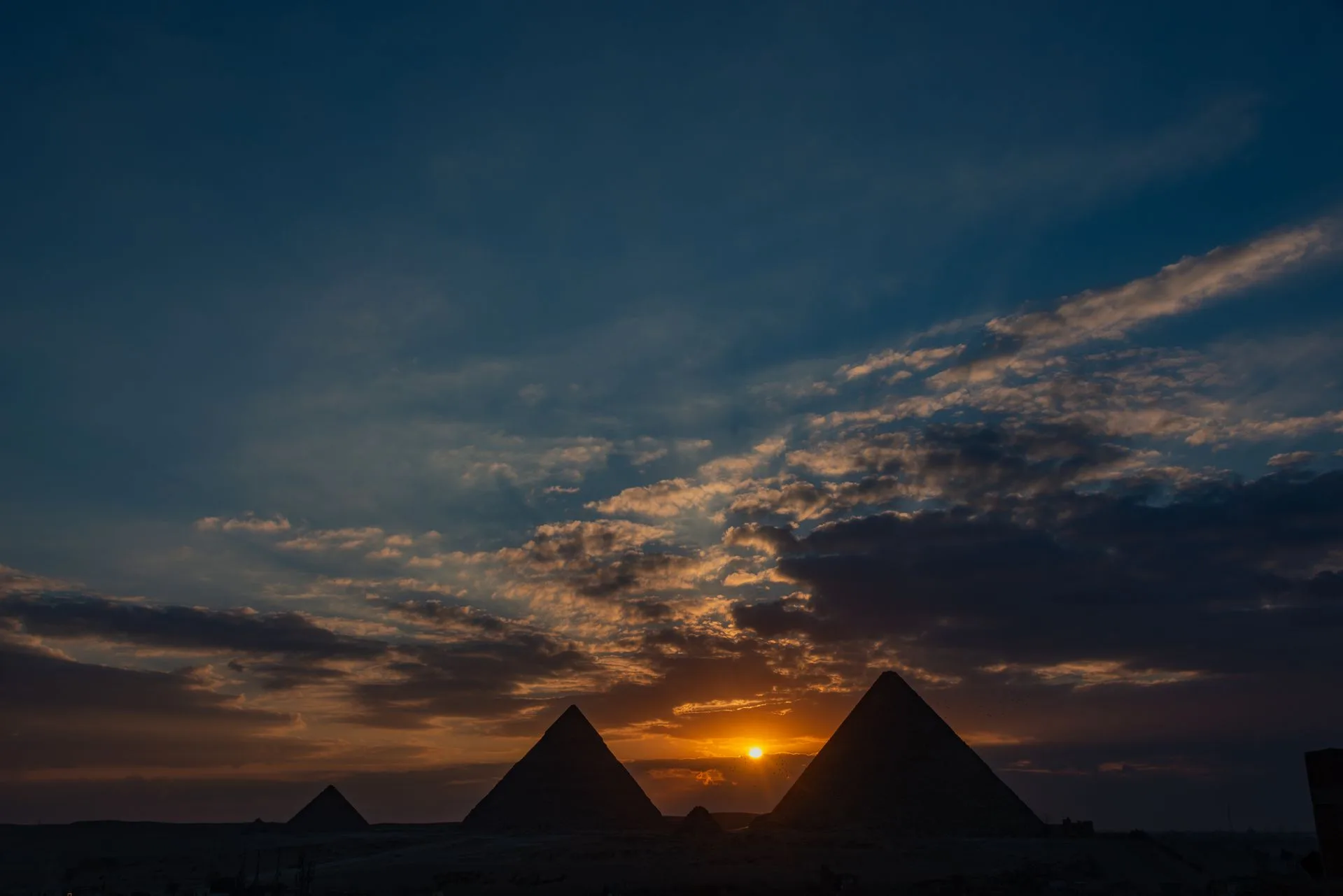 Pyramids of Giza at sunset with golden light