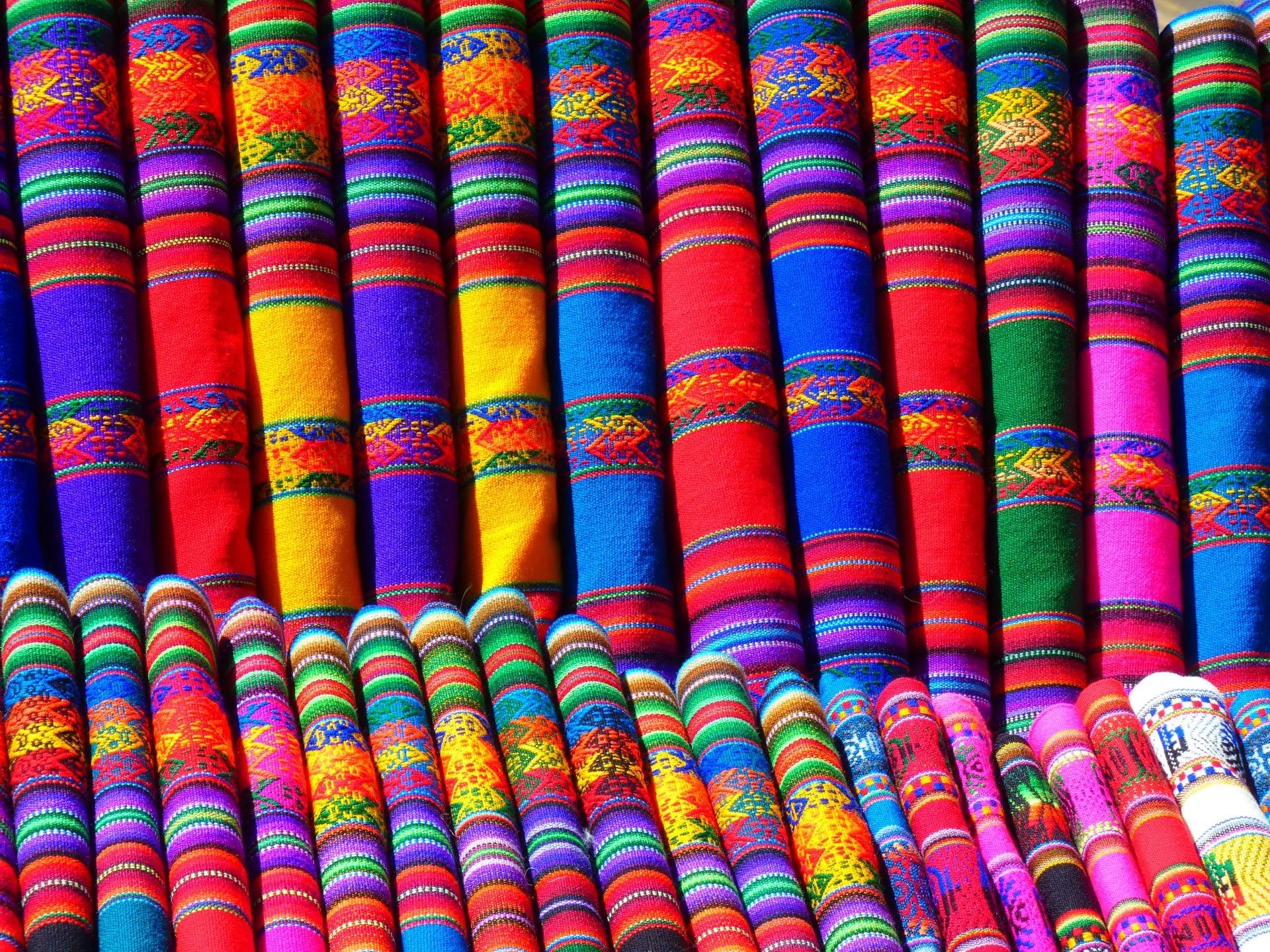 Colorful produce and textiles displayed at Analakely Market stalls