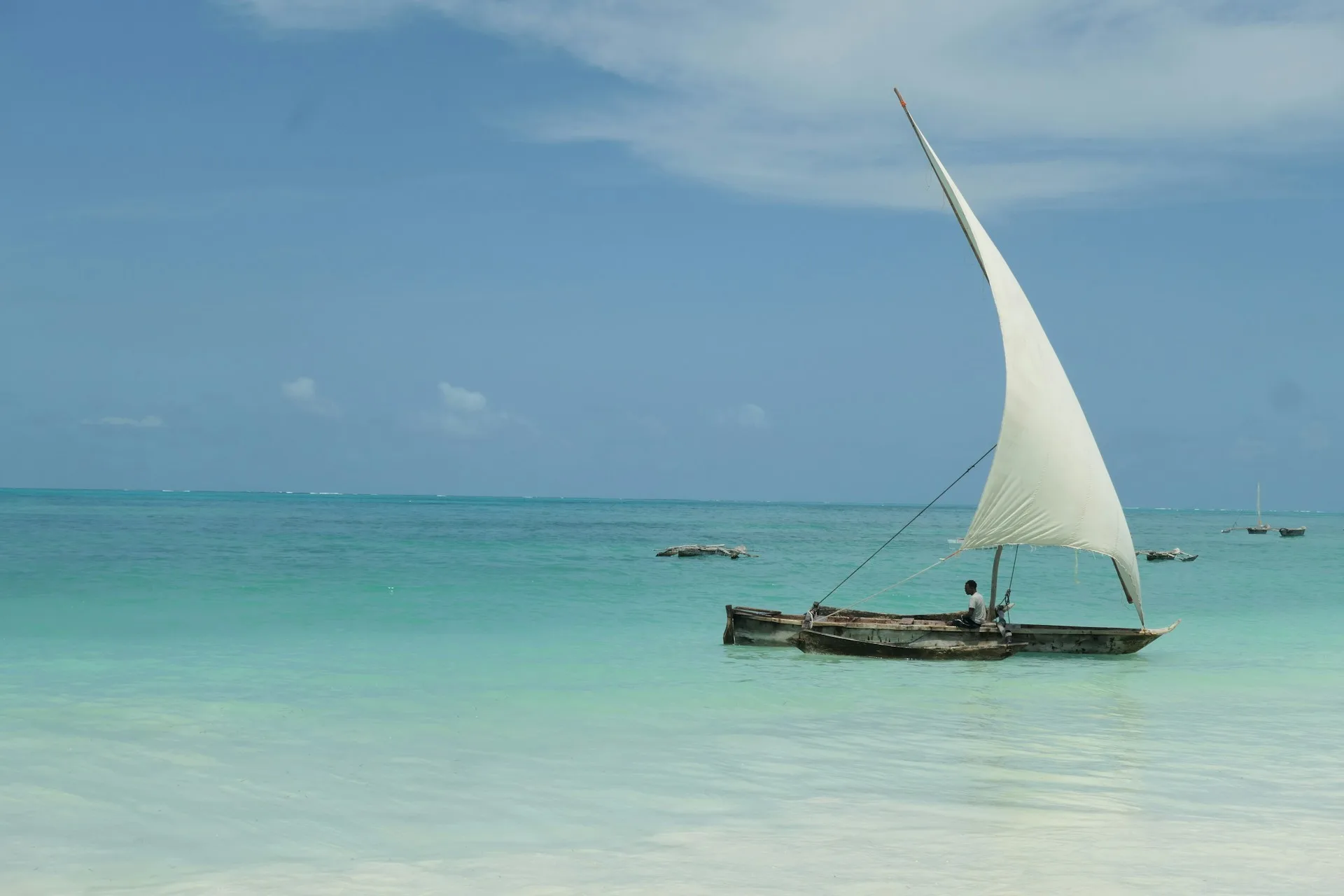 Spectacular sunset over Zanzibar beach with dhow boats and turquoise waters