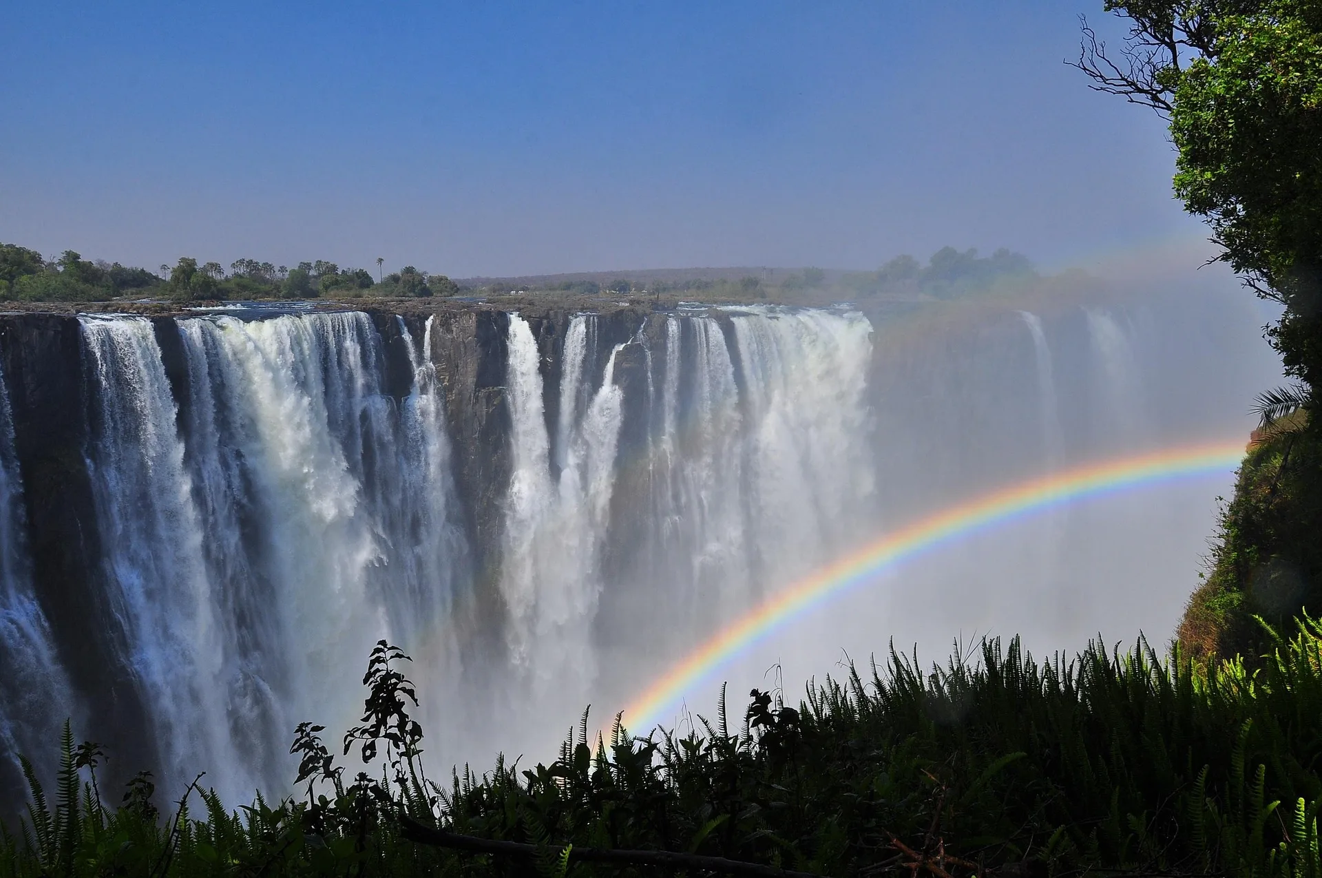 Victoria Falls with rainbow through mist