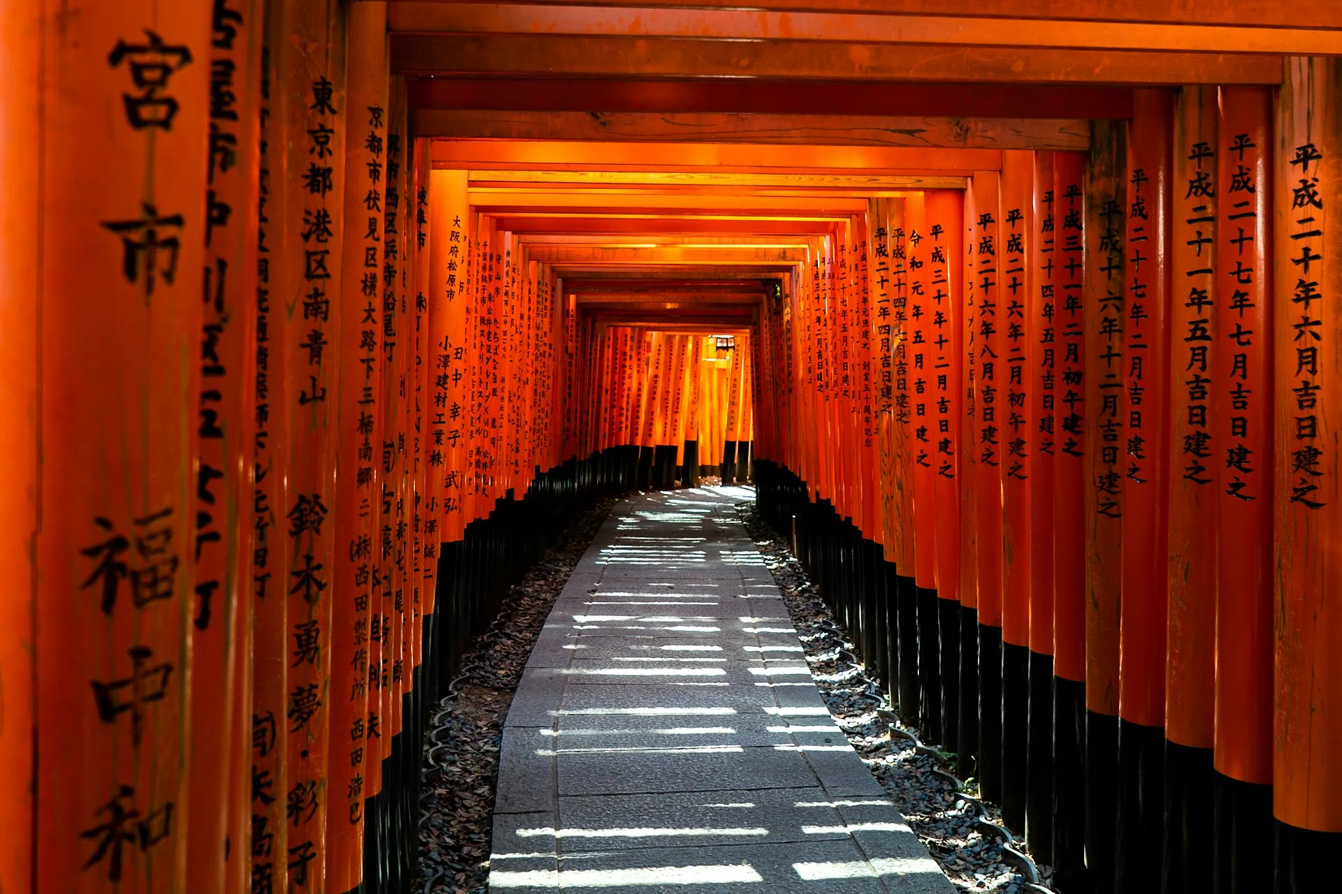 Fushimi Inari orange torii gates creating tunnel pathway