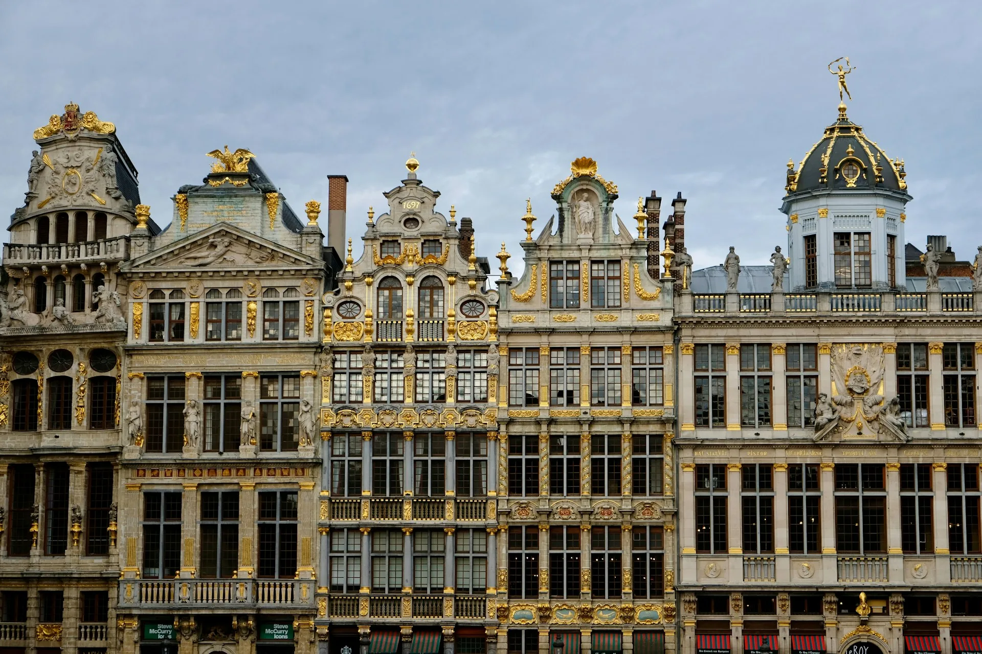 Grand Place Brussels illuminated at blue hour with golden guildhalls