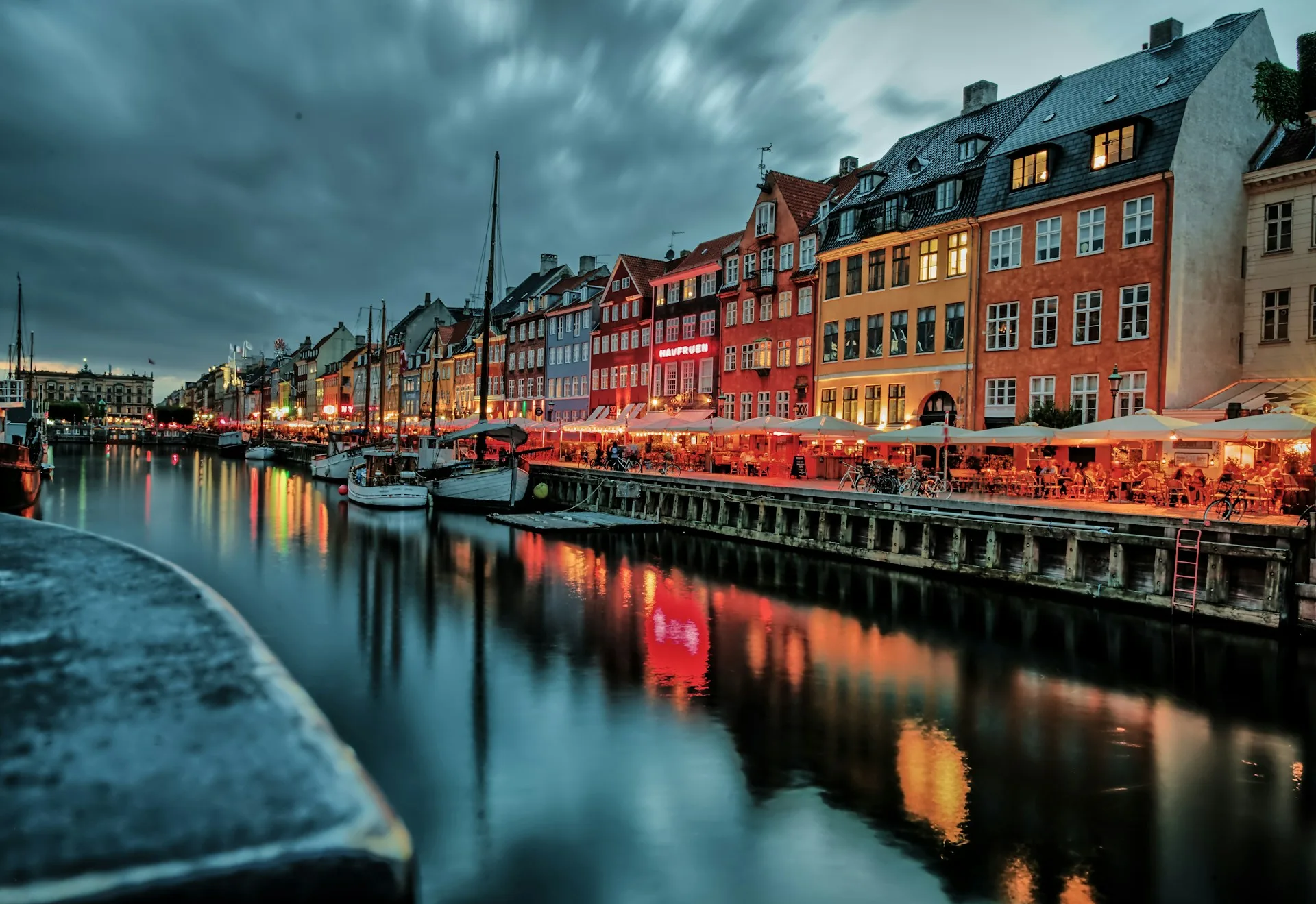 Nyhavn colorful harbor with boats and historic townhouses in Copenhagen
