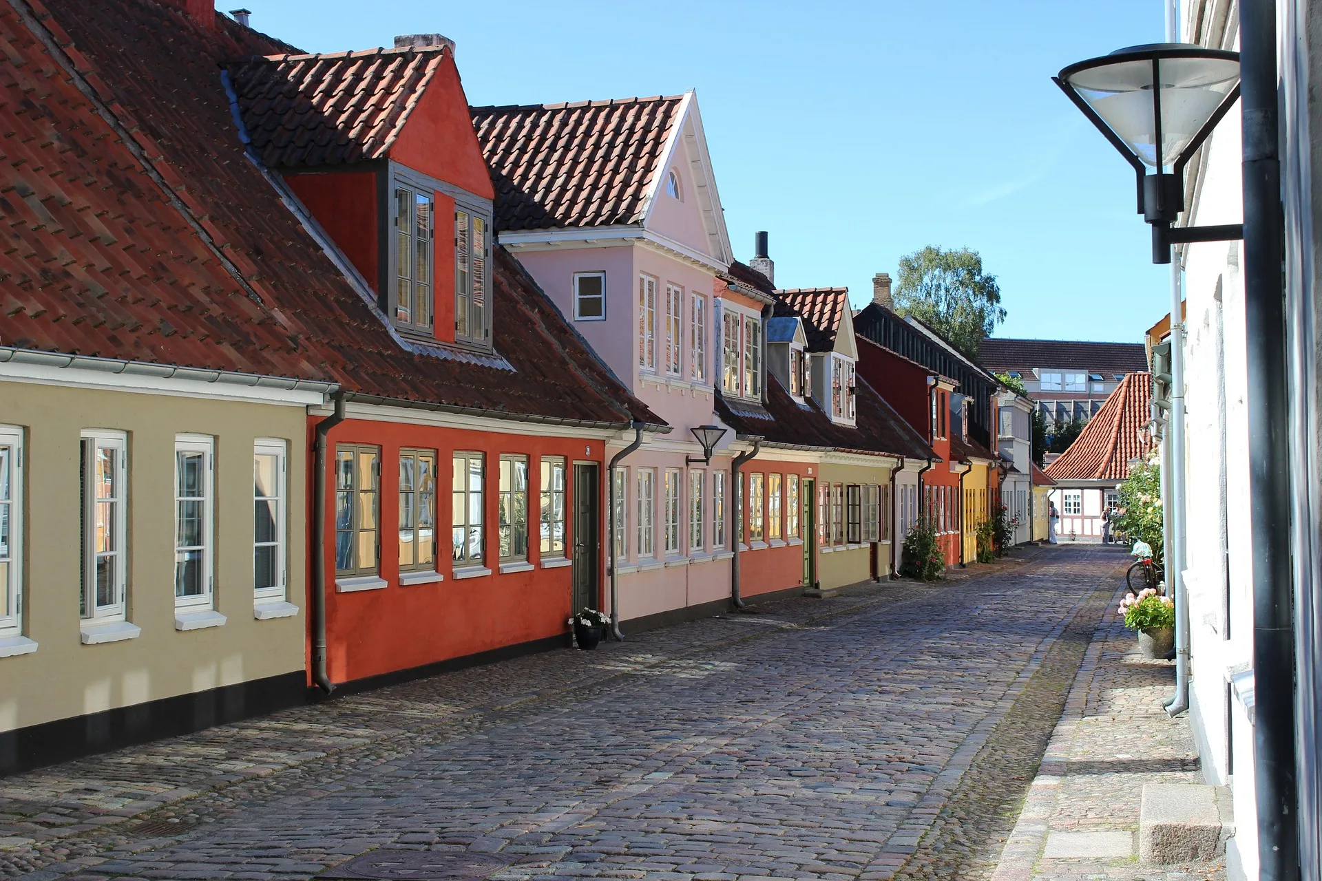 Historic cobblestone streets with colorful houses in Odense old town