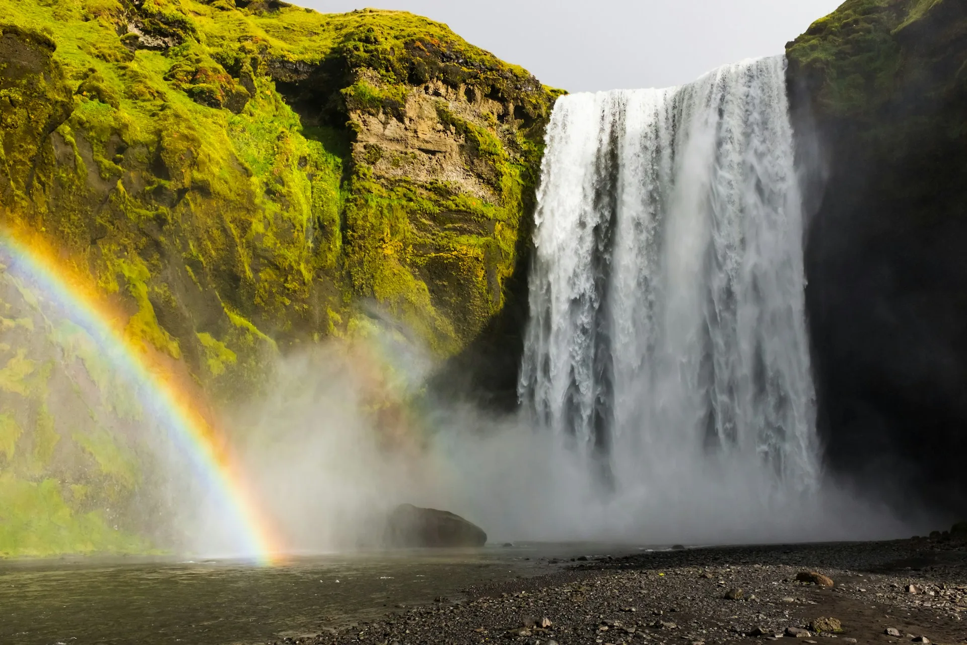 Skógafoss waterfall with rainbow in Iceland