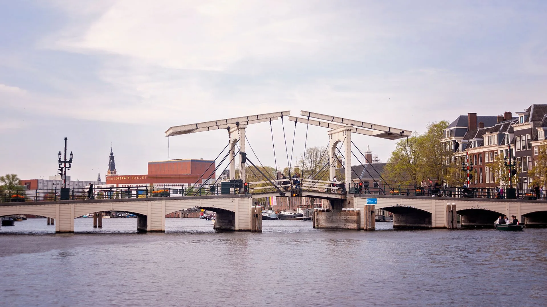 Amsterdam Magere Brug at sunset with canal reflections