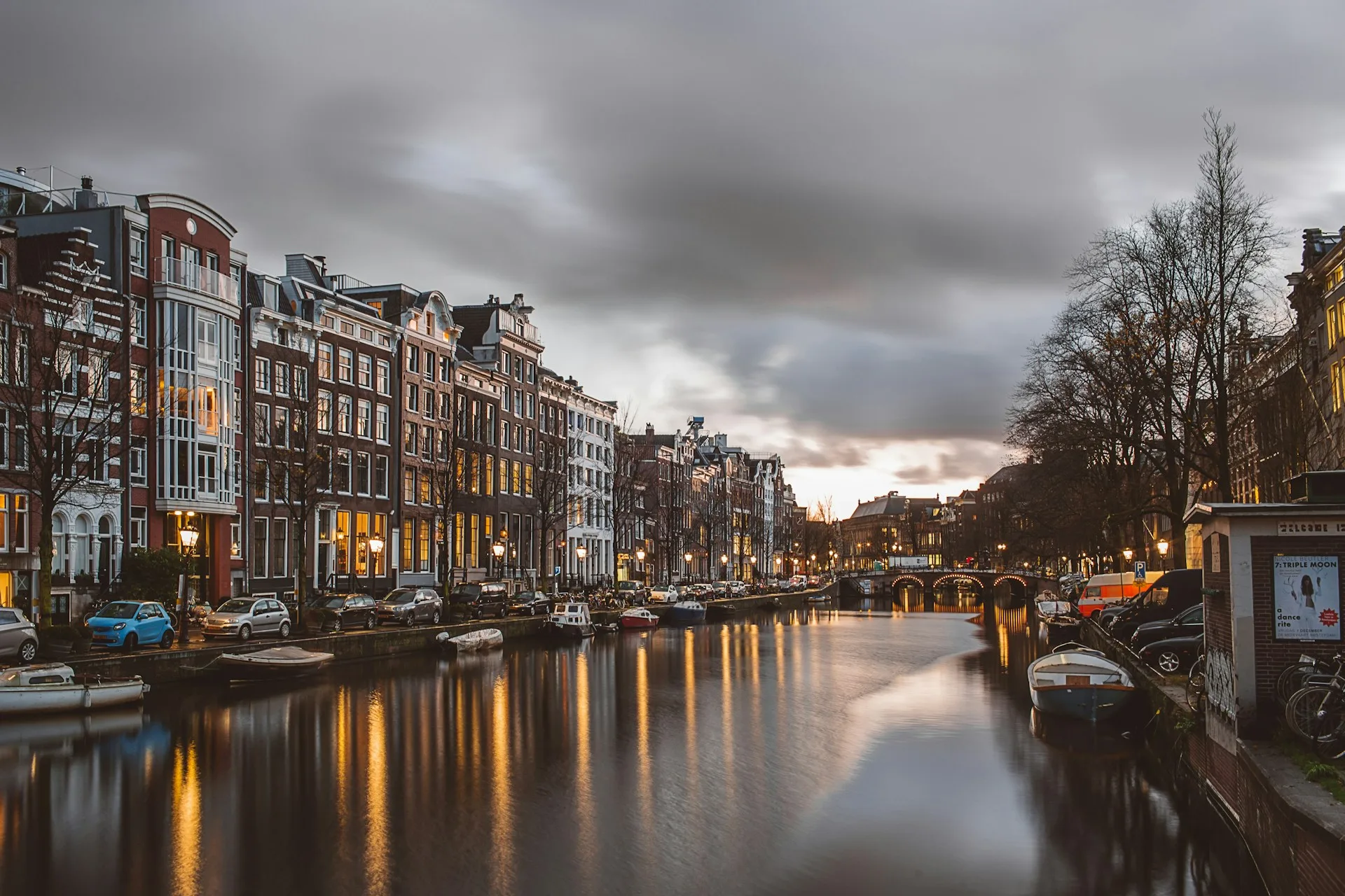 Historic Amsterdam canal houses and bridges in evening light