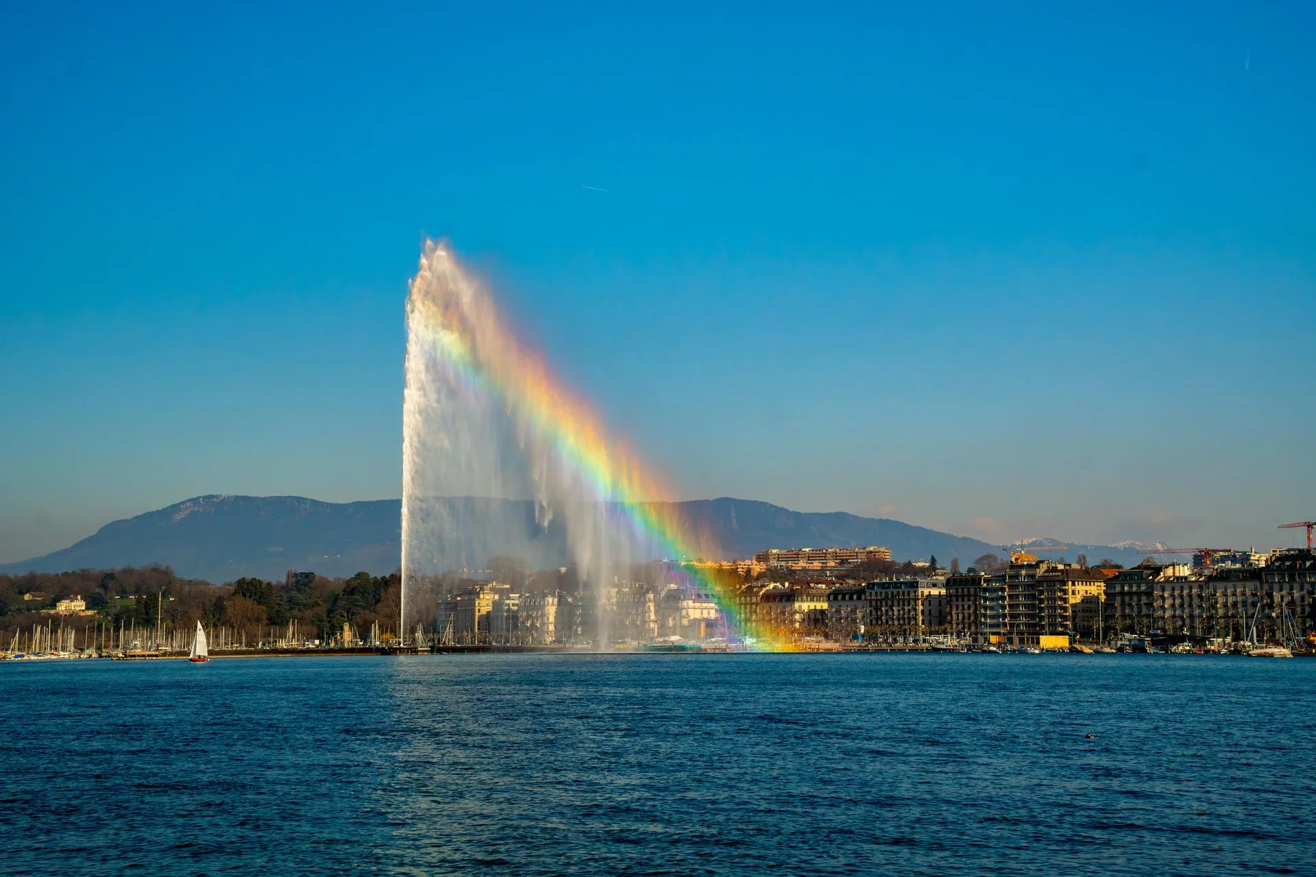 Jet d'Eau fountain on Lake Geneva with Alps in background