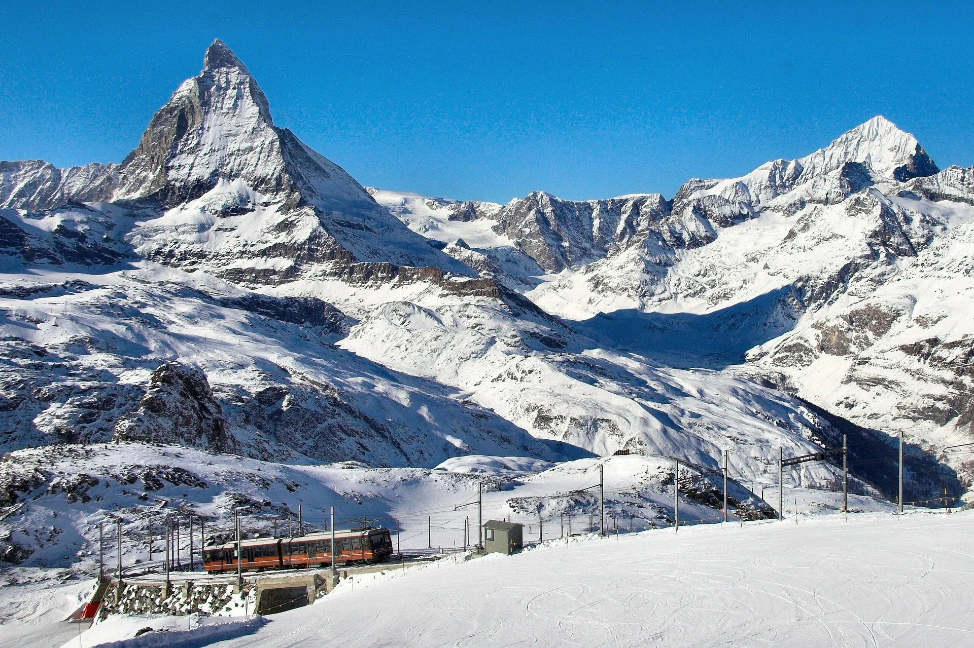 Gornergrat cogwheel train ascending with Matterhorn mountain backdrop