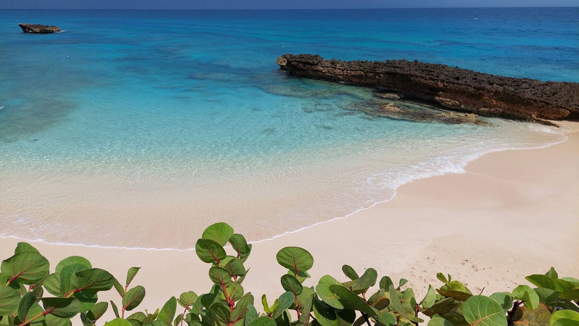 Crane Beach Barbados with distinctive pink-tinged coral sand, turquoise waters and dramatic cliff backdrop - best photography spot