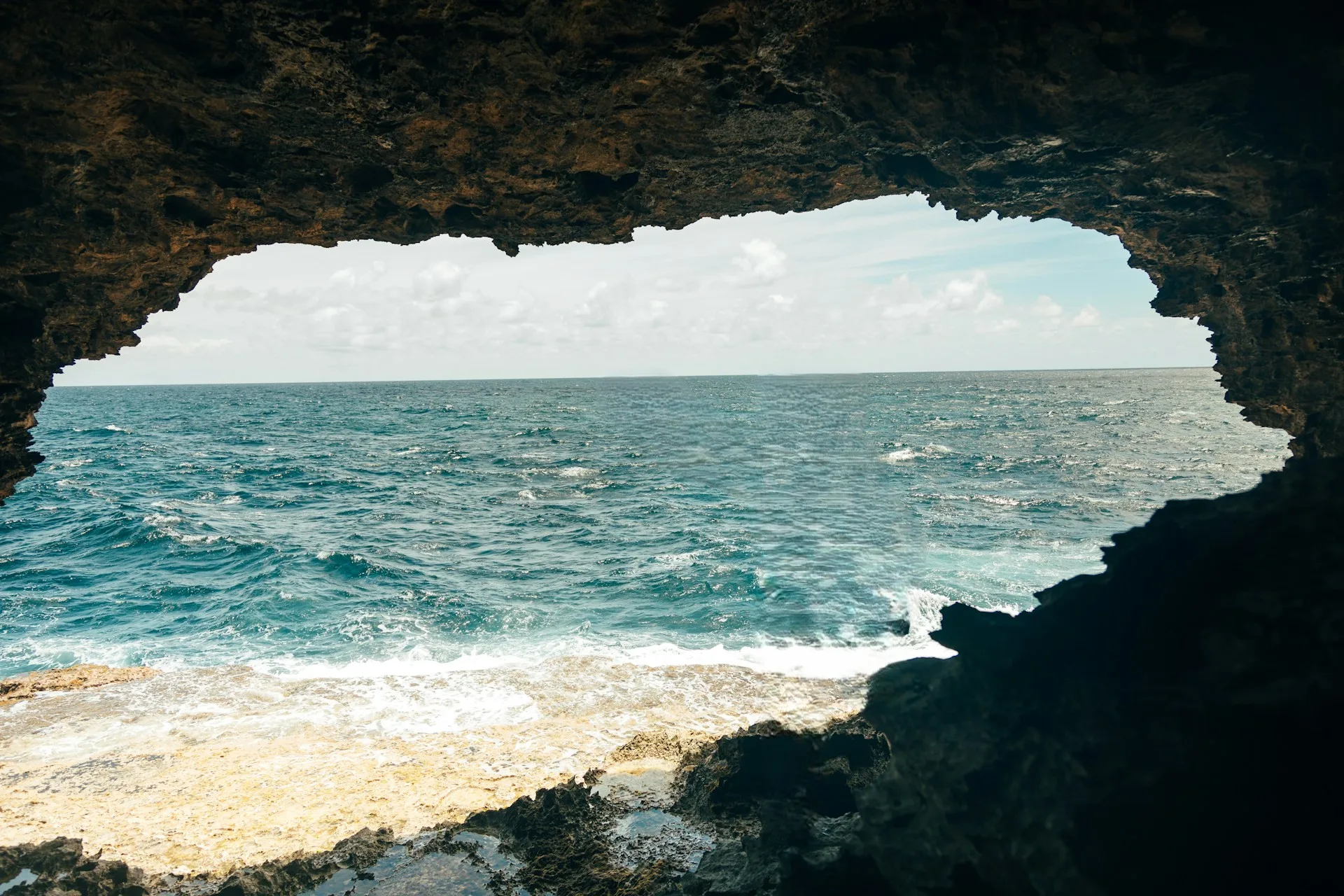 Animal Flower Cave Barbados with turquoise Atlantic Ocean views through natural rock openings and cave formations