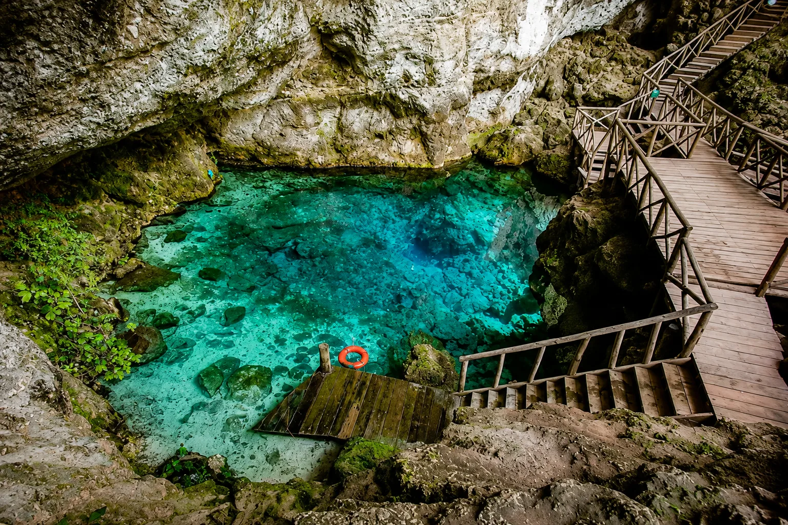 Hoyo Azul cenote with turquoise water surrounded by jungle
