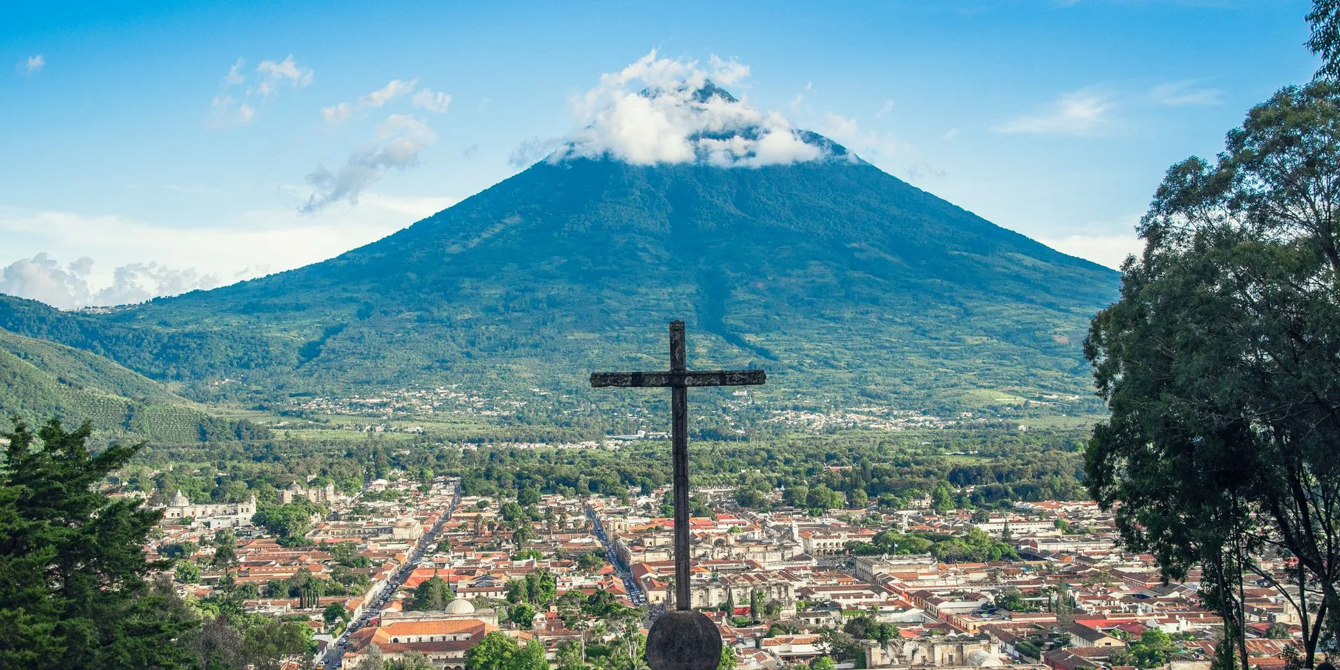 Colonial cobblestone streets of Antigua Guatemala with Volcán de Agua backdrop - Day 1 Arrival in Guatemala Family Tour Package