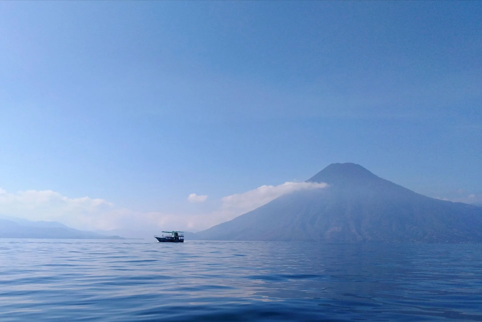 Lake Atitlan dock with three volcanoes in background Guatemala