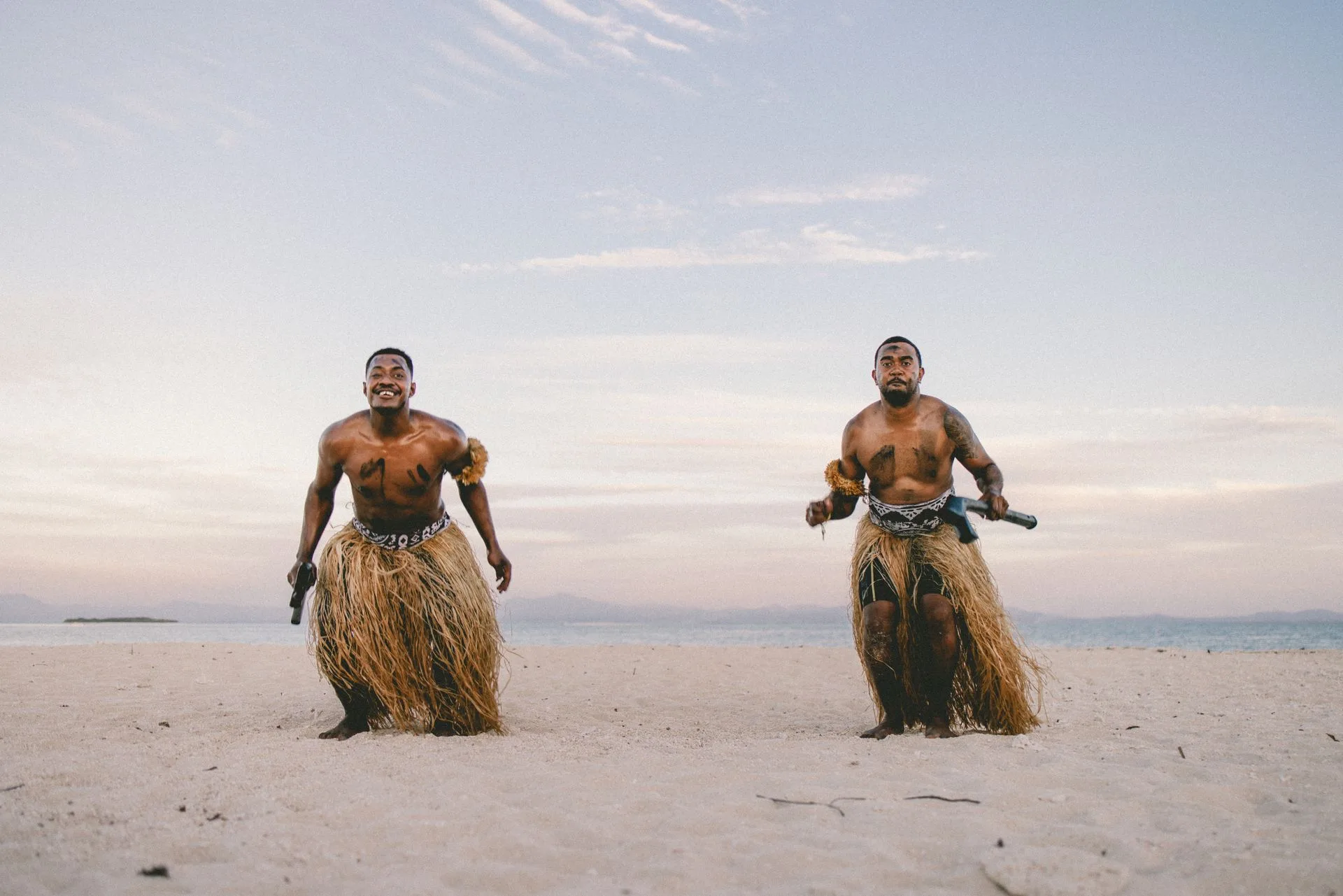 Family participating in traditional Fijian village ceremony