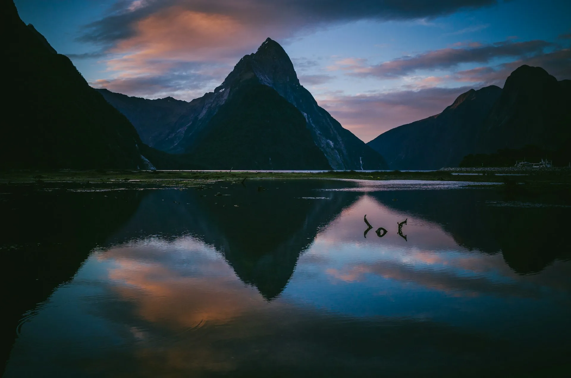 Milford Sound sunrise photography with Mitre Peak and reflections