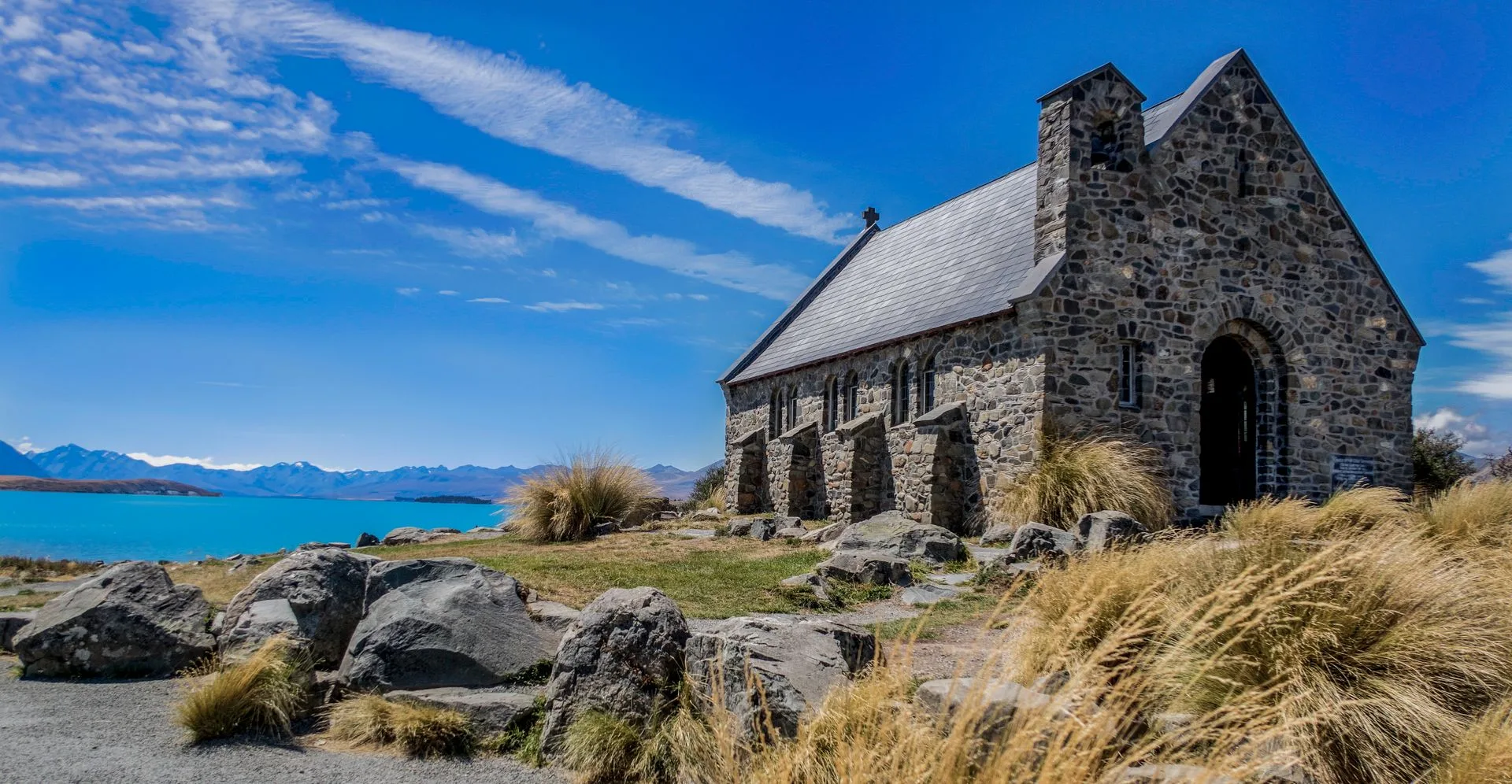 Church of the Good Shepherd at Lake Tekapo with turquoise water and mountains