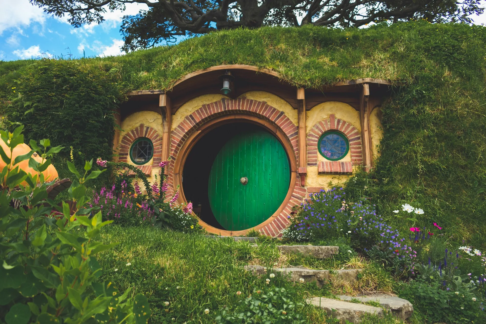 Hobbiton movie set with colorful hobbit holes and gardens