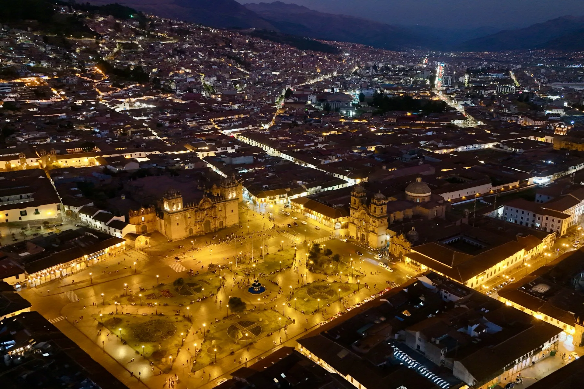 Illuminated Cusco Plaza de Armas at twilight